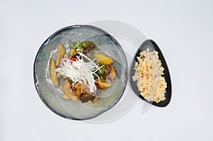 Closeup shot of a dish with pork and vegetables and rice as sidedish