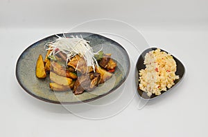 Closeup shot of a dish with pork and vegetables and rice as sidedish