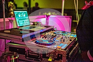 Closeup shot of a DJ set in the dark party hall