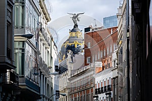 Closeup shot of a dome with Victoria statue, Metropolis Building, Madrid, Spain