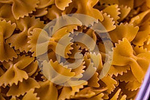 Closeup shot of dry uncooked farfalle pasta