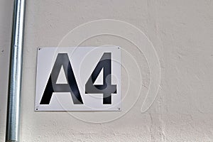 Closeup shot of the entrance gate sign and number A4 of the stadion's white wall