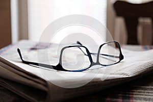 Closeup shot of eyeglasses on the stack of newspapers - learning concept