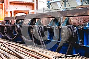 Closeup shot of a factory during the work of machineries with wheels