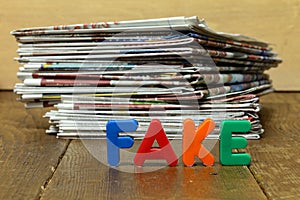 Closeup shot of Fake news concept with newspapers and letters.