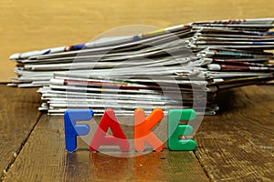 Closeup shot of Fake news concept with newspapers and letters.