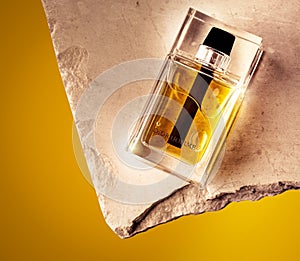 Closeup shot of a famous perfume bottle with a yellow background