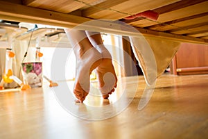 Closeup shot of female feet under bed photo