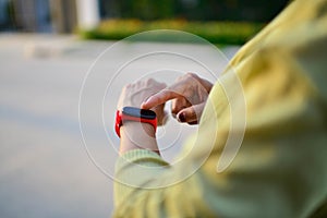 Closeup shot of female hand checking her  smartwatch.