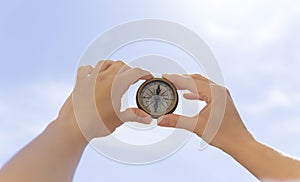 Closeup shot of a female hand holding an old compass