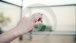 Closeup shot of female hands holding smartphone, typing text on touch screen. Woman answering friend message in social