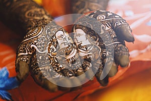 Closeup shot of female hands with mehndi tattoo, one of the rituals of the Indian weddings