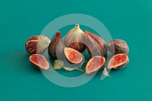 Closeup shot of fig fruits in a cut on reen background
