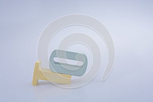 Closeup shot of the figures of letters T and O on a white surface