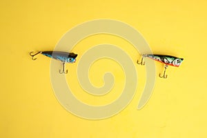 Closeup shot of fishing baits isolated on a yellow background