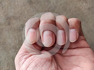 Closeup shot of folded hand and fingers with neatly cared nails