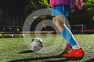 closeup shot of a football player getting ready to kick a soccer ball, stadium, sportswear, active life