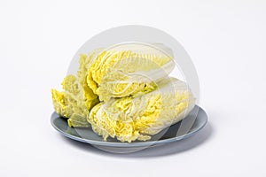 Closeup shot of fresh chinese cabbage â€‹on the plate isolated on white background