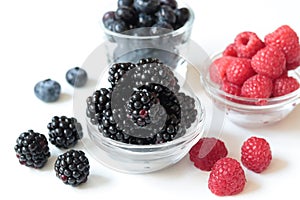 Closeup shot of fresh mixed berries on a bowl isolated on a white background