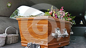 Closeup shot of a funeral casket in a hearse or chapel or burial at cemetery