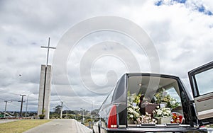 Closeup shot of a funeral casket in a hearse or chapel or burial at cemetery