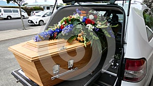 Closeup shot of a funeral casket in a hearse or chapel or burial at cemetery