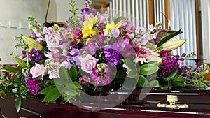 Closeup shot of a funeral casket in a hearse or chapel or burial at cemetery