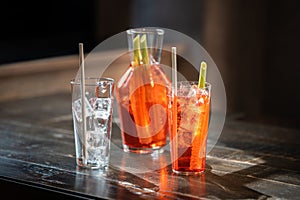 Closeup shot of glass Bloody Mary cocktails on a wooden table