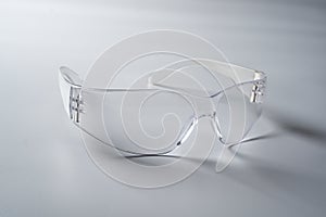 Closeup shot of glasses with the transparent frame on a gray background