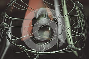 Closeup shot of glue stick strings on a glass with water droplets on a dark background