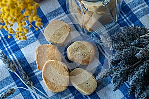 Closeup shot of gluten-free cookies with rice flour on a blue checkered tablecloth