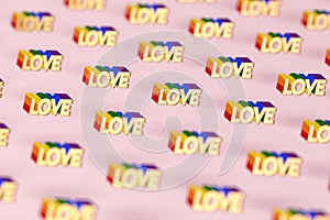 Closeup shot on Golden LOVE word with rainbow outline pattern. June as a month of gay pride and love concept.  on pink