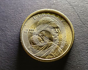 Closeup shot of a golden Sacagawea dollar coin on a gray surface photo