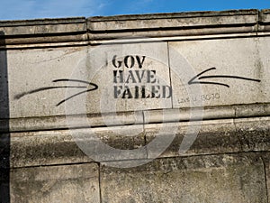Closeup shot of a "Gov have failed" graffiti on a street building