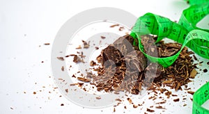 Closeup shot of grated chocolate with a green sentiment against a white background