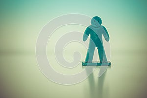 Closeup shot of a green decorative human figurine toy on a light background