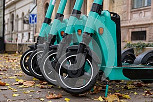 Closeup shot of green electric scooters with black wheels parked on a street