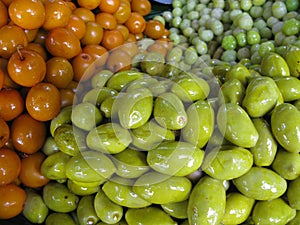 Closeup shot of green and orange olives bunch