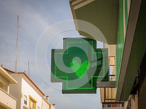 Closeup shot of a green pharmacy sign with heart in it