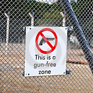 Closeup shot of a gun-free zone sign on a fence