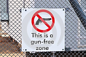 Closeup shot of a gun-free zone sign on a fence