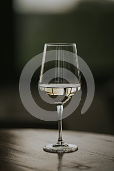 Closeup shot of a half-full white wine glass