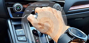 Closeup shot of hand on a car gear shifter