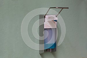 Closeup shot of a hand sanitizer dispenser attached to a wall
