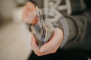 Closeup shot of hands holding playing cards