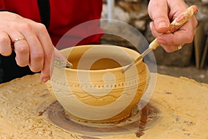 Closeup shot of the hands of a potter creating a jar