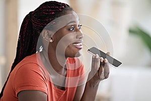 Closeup Of Happy Black Woman Recording Voice Message On Smartphone At Home