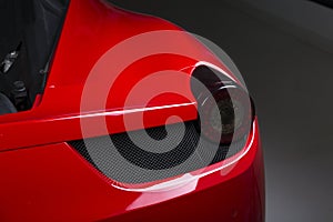 Closeup shot of the headlights of a modern red car