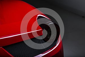 Closeup shot of the headlights of a modern red car