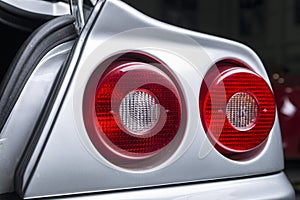 Closeup shot of the headlights of a modern silver car